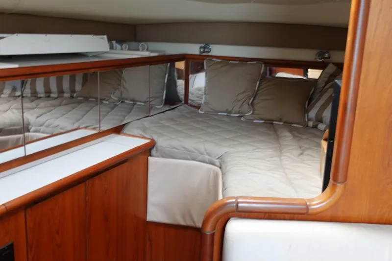  Yacht Photos Pics Luxurious cabin interior of a 1997 Pursuit 3400 Offshore boat with cozy bedding.