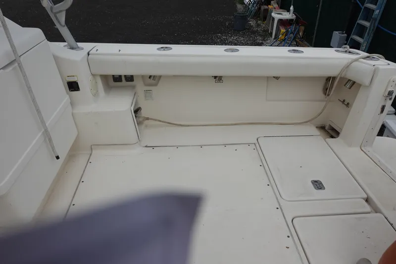  Yacht Photos Pics 1997 Pursuit 3400 Offshore boat deck with storage compartments and fishing rod holders.