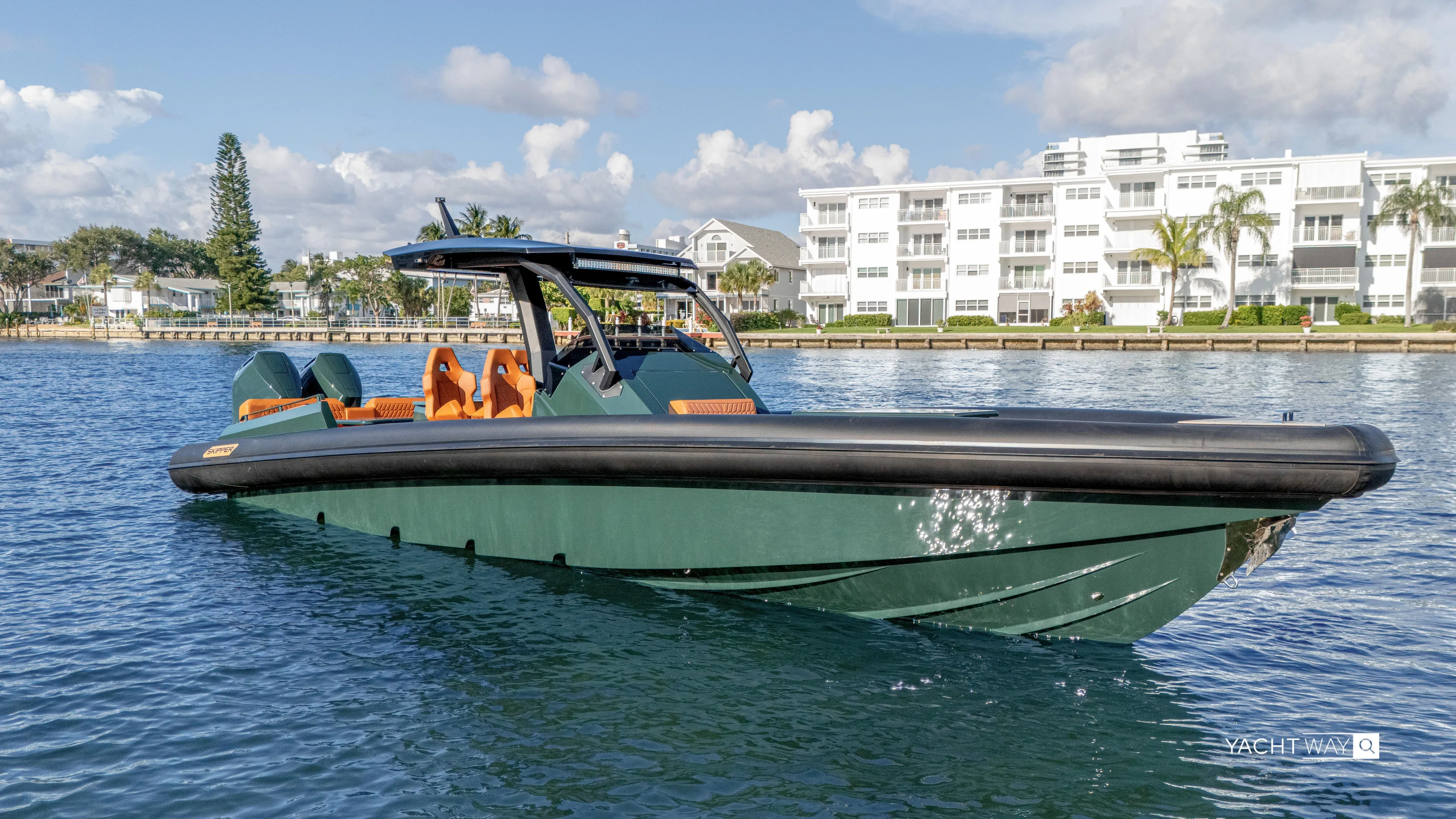 New 2025 Skipper 38 Twin 400 V10 Yacht Photos Pics 2025 Skipper-BSK 38 boat on water, modern design, near waterfront buildings.