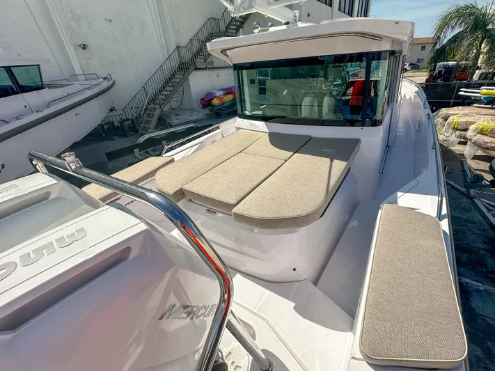  Yacht Photos Pics 2024 Axopar 37XC CROSS CABIN boat with cushioned seating and sleek design.