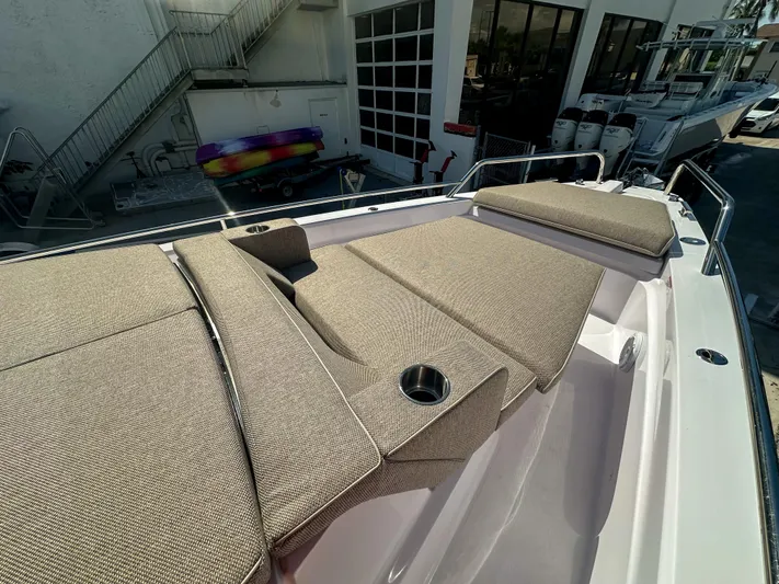  Yacht Photos Pics 2024 Axopar 37XC CROSS CABIN with beige sunbathing cushions and cup holders on deck.