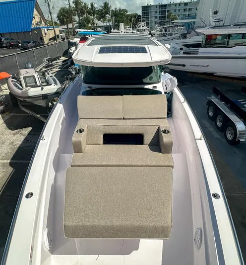  Yacht Photos Pics 2024 Axopar 37XC CROSS CABIN with sunbed, docked in a marina.