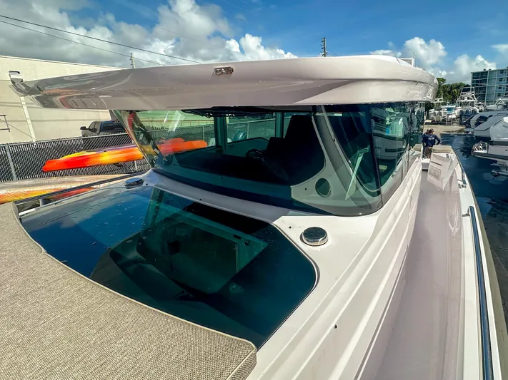  Yacht Photos Pics 2024 Axopar 37XC CROSS CABIN boat with sleek design and panoramic windows.