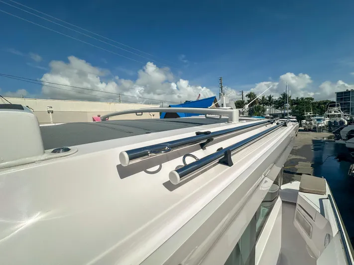  Yacht Photos Pics 2024 Axopar 37XC CROSS CABIN boat roof with railings under clear blue sky.
