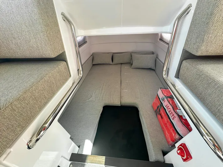  Yacht Photos Pics 2024 Axopar 37XC CROSS CABIN interior with cozy sleeping area and safety equipment.