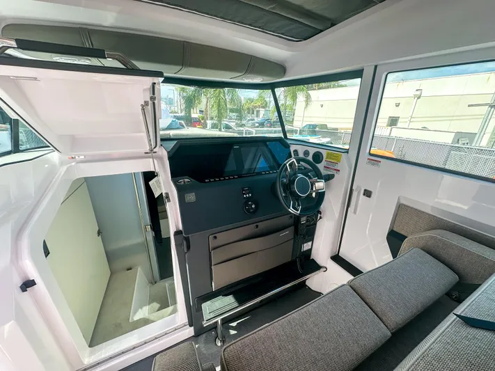  Yacht Photos Pics 2024 Axopar 37XC CROSS CABIN interior with modern helm and seating.