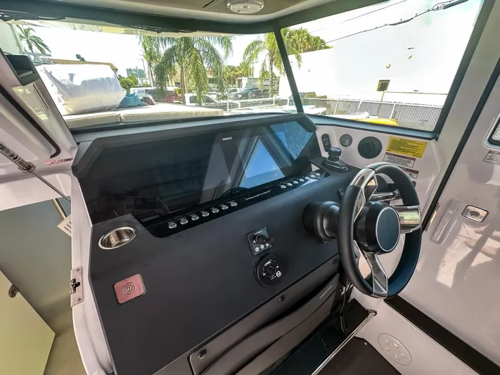  Yacht Photos Pics 2024 Axopar 37XC CROSS CABIN helm with modern controls and steering wheel.