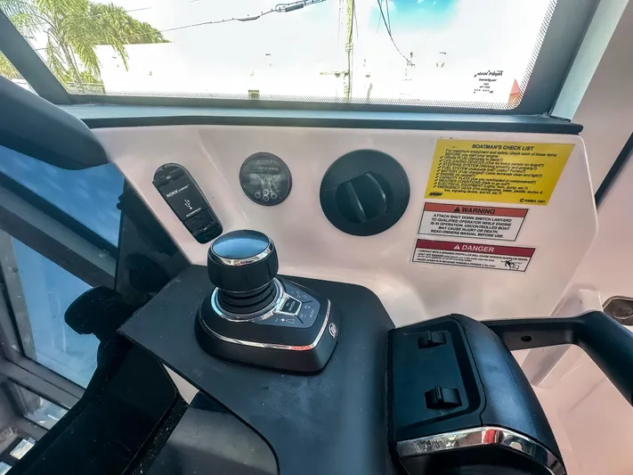  Yacht Photos Pics 2024 Axopar 37XC CROSS CABIN dashboard with control panel and warning labels.