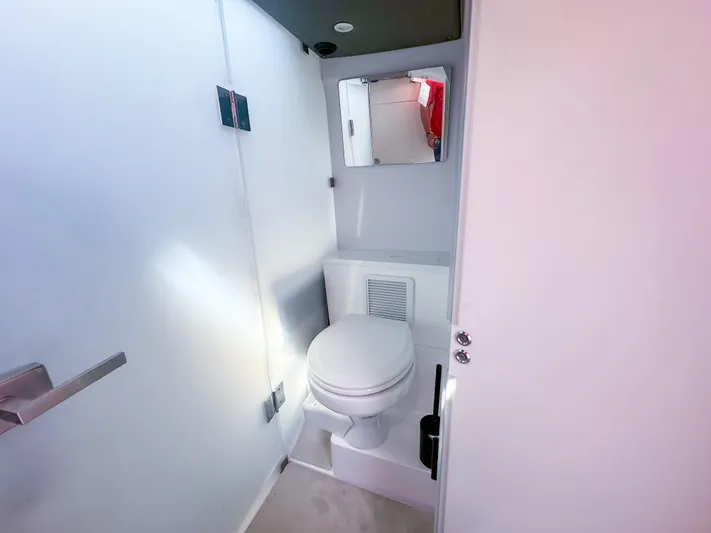  Yacht Photos Pics 2024 Axopar 37XC CROSS CABIN bathroom interior with toilet and mirror.