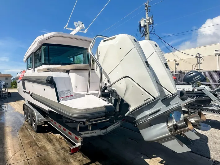  Yacht Photos Pics 2024 Axopar 37XC CROSS CABIN boat on trailer, featuring dual outboard engines.