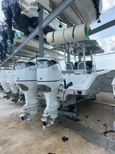  Yacht Photos Pics 2024 Sea Pro 320 DLX Center Console boat with dual Suzuki outboard engines in storage.