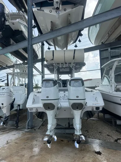 Yacht Photos Pics 2024 Sea Pro 320 DLX Center Console with dual outboard engines in a boat storage facility.