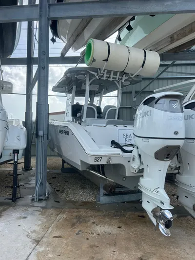  Yacht Photos Pics 2024 Sea Pro 320 DLX Center Console boat with dual Suzuki engines in storage.