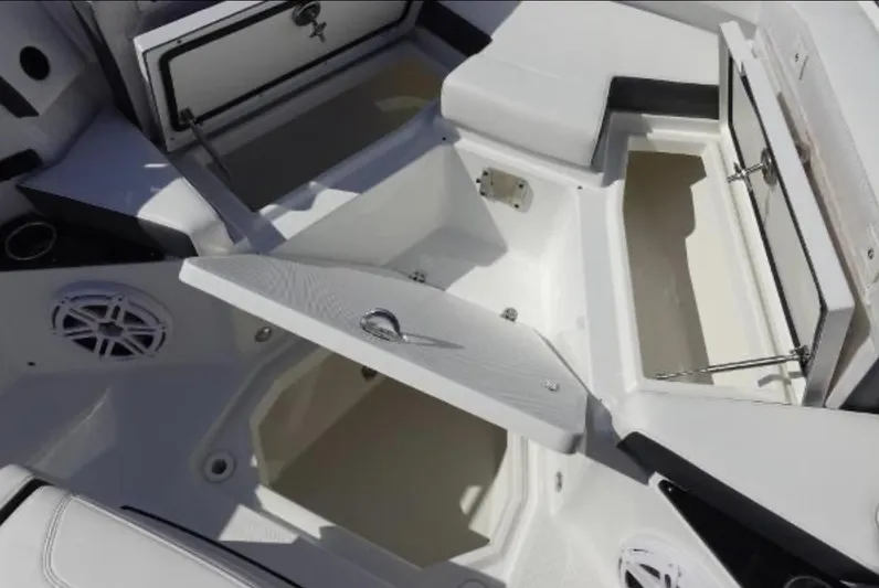  Yacht Photos Pics 2021 Blackfin 272 CC boat storage compartments open, showcasing spacious interior design.