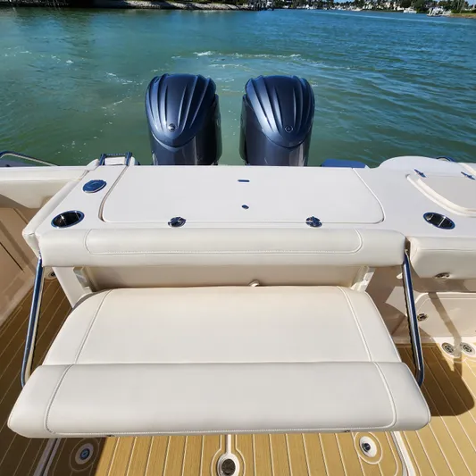 Liquid Asset Yacht Photos Pics 2022 Grady-White 326 CANYON boat with twin outboard engines and cushioned seating.