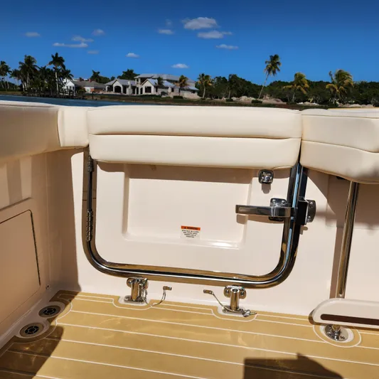 Liquid Asset Yacht Photos Pics 2022 Grady-White 326 CANYON boat interior with cushioned seating and scenic background.