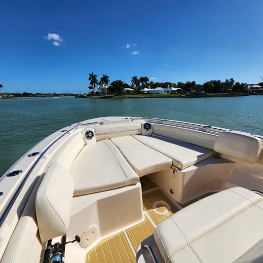 Liquid Asset Yacht Photos Pics 2022 Grady-White 326 CANYON boat interior with cushioned seating on a sunny day.
