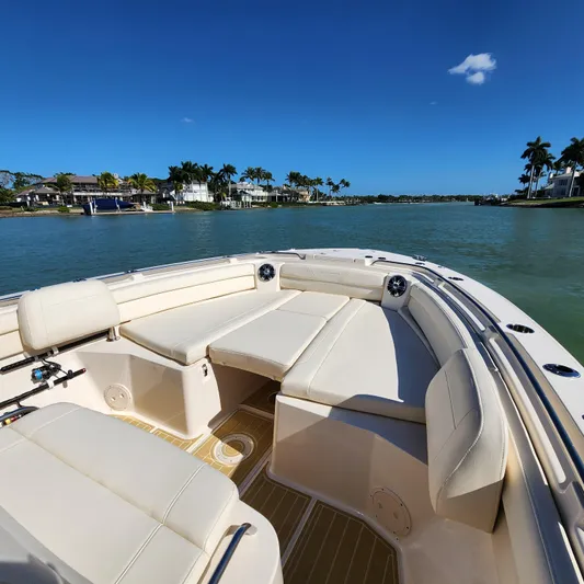 Liquid Asset Yacht Photos Pics 2022 Grady-White 326 CANYON boat with spacious seating on a sunny day.