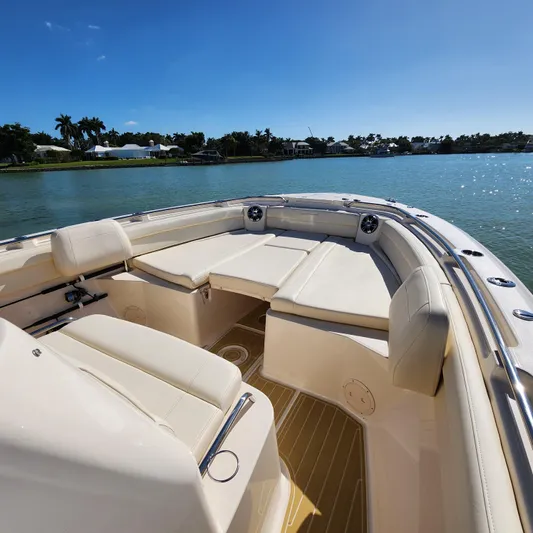 Liquid Asset Yacht Photos Pics 2022 Grady-White 326 CANYON boat interior with cushioned seating on a sunny day.