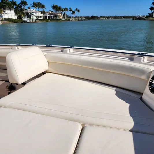 Liquid Asset Yacht Photos Pics 2022 Grady-White 326 CANYON boat with comfortable seating, on a sunny day by the water.