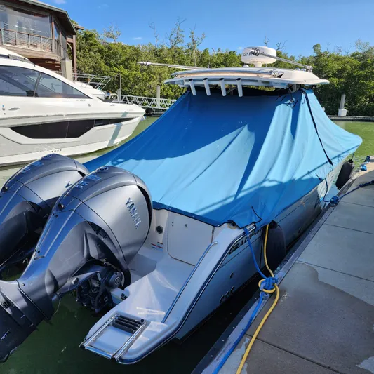 Liquid Asset Yacht Photos Pics 2022 Grady-White 326 CANYON boat with blue cover docked, featuring twin Yamaha outboard engines.
