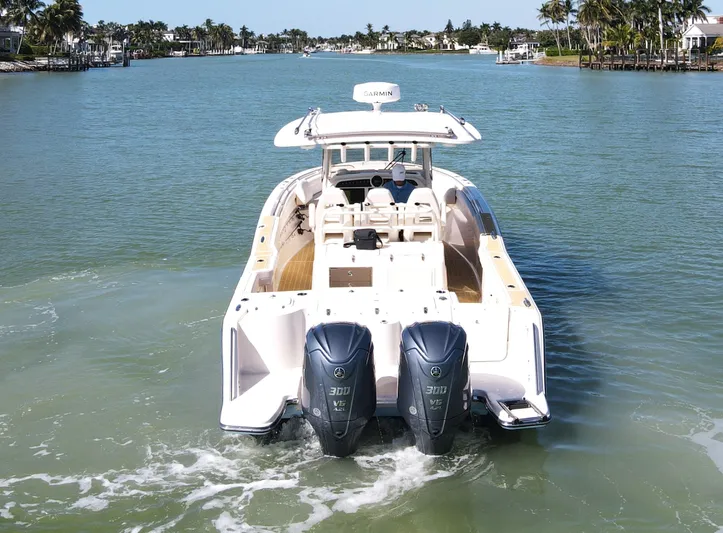 Liquid Asset Yacht Photos Pics 2022 Grady-White 326 CANYON boat cruising on a scenic waterway.