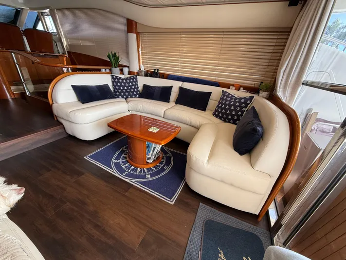 Just Chillin Yacht Photos Pics Luxurious interior of 2006 Viking Princess 61 Flybridge yacht with elegant seating and wooden accents.