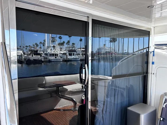 Just Chillin Yacht Photos Pics 2006 Viking Princess 61 Flybridge yacht with marina view through glass doors.