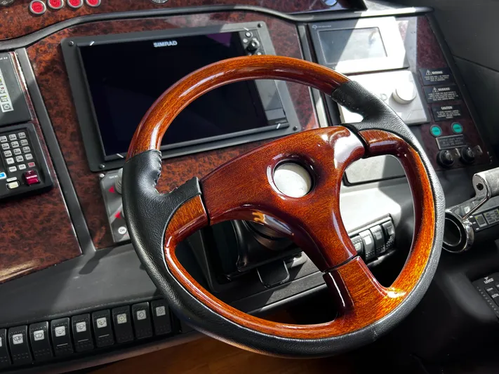 Just Chillin Yacht Photos Pics Luxurious 2006 Viking Princess 61 Flybridge helm with wood and leather steering wheel.