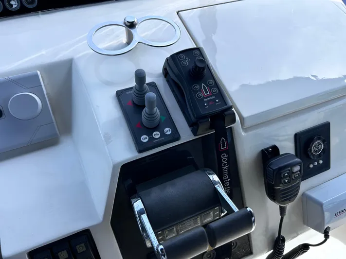 Just Chillin Yacht Photos Pics Control panel of 2006 Viking Princess 61 Flybridge yacht with joystick and communication devices.