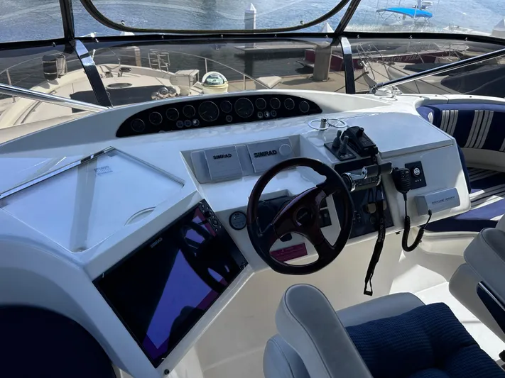 Just Chillin Yacht Photos Pics Helm of 2006 Viking Princess 61 Flybridge yacht with navigation controls and steering wheel.