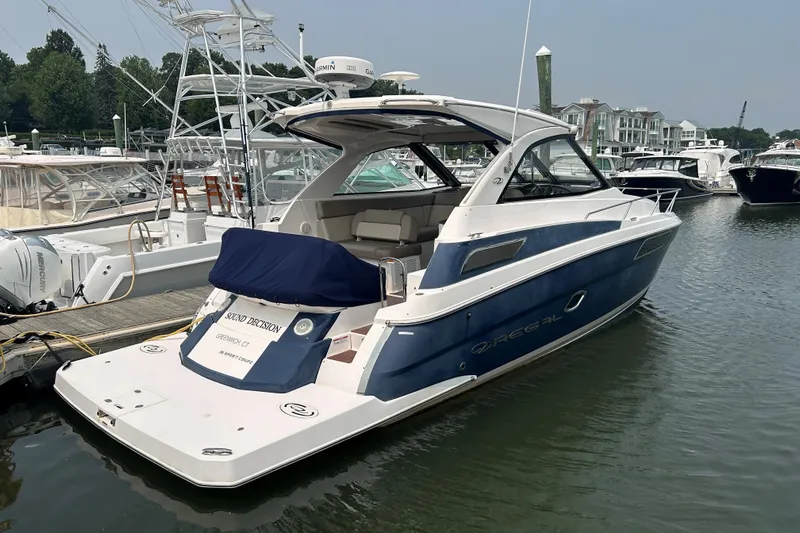 Sound Decision Yacht Photos Pics 2013 Regal 35 Sport Coupe yacht docked at marina, featuring sleek design and blue hull.