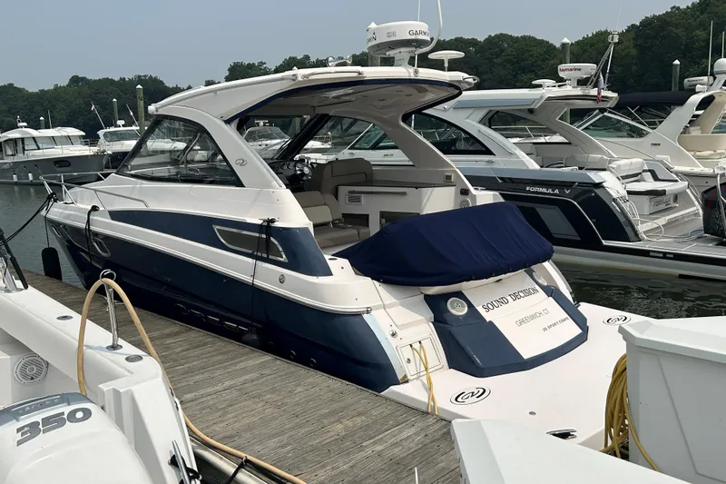 Sound Decision Yacht Photos Pics 2013 Regal 35 Sport Coupe docked at marina, surrounded by other boats.