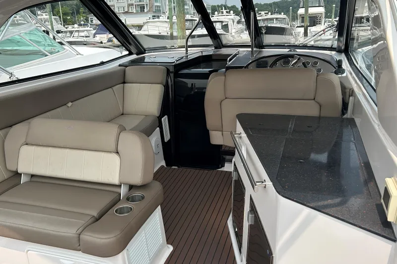 Sound Decision Yacht Photos Pics Interior of 2013 Regal 35 Sport Coupe with beige seating and sleek countertops.