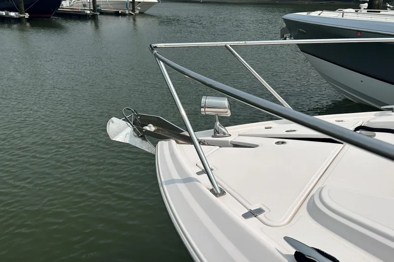 Sound Decision Yacht Photos Pics 2013 Regal 35 Sport Coupe bow with anchor, docked on calm water.
