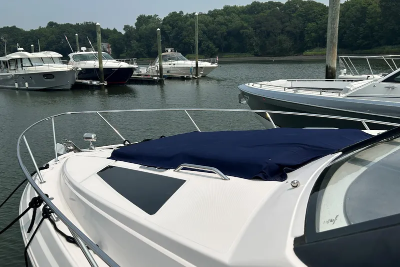 Sound Decision Yacht Photos Pics 2013 Regal 35 Sport Coupe docked in a marina with other boats.