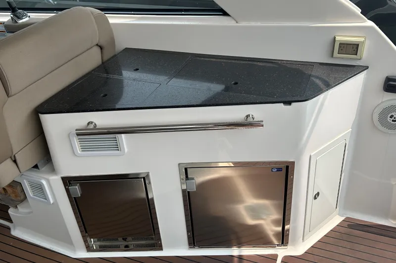 Sound Decision Yacht Photos Pics 2013 Regal 35 Sport Coupe interior with kitchenette and stainless steel appliances.