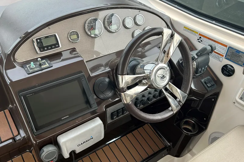 Sound Decision Yacht Photos Pics Dashboard of a 2013 Regal 35 Sport Coupe with steering wheel and Garmin navigation system.