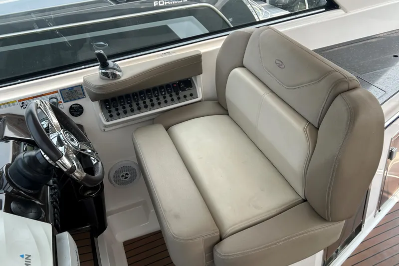 Sound Decision Yacht Photos Pics Captain's seat and controls of a 2013 Regal 35 Sport Coupe boat.