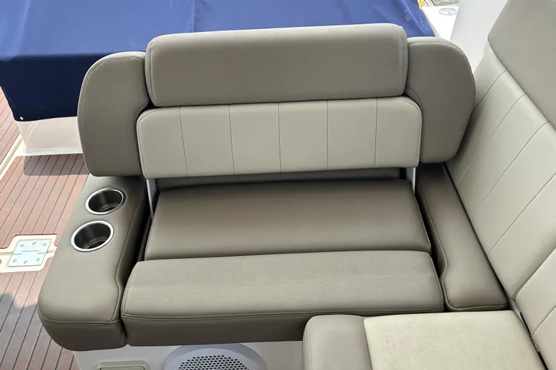 Sound Decision Yacht Photos Pics 2013 Regal 35 Sport Coupe boat seating with cup holders and beige upholstery.