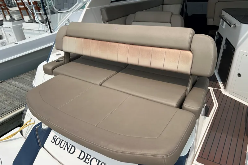 Sound Decision Yacht Photos Pics 2013 Regal 35 Sport Coupe boat with beige seating and "Sound Decision" nameplate.