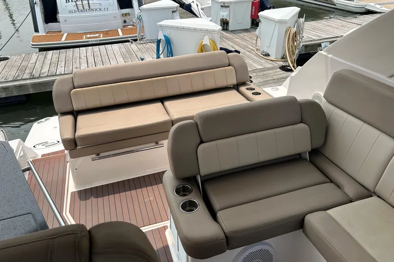 Sound Decision Yacht Photos Pics 2013 Regal 35 Sport Coupe boat interior with beige seating at a marina.