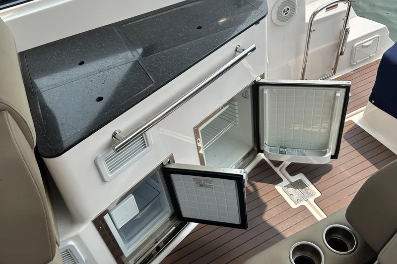 Sound Decision Yacht Photos Pics Open mini fridge on 2013 Regal 35 Sport Coupe boat with wood flooring.