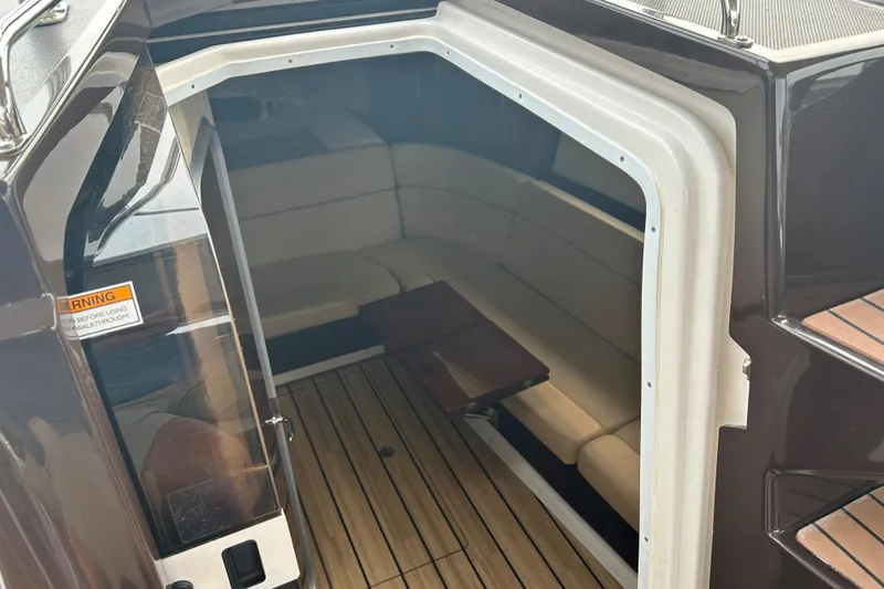 Sound Decision Yacht Photos Pics Interior view of 2013 Regal 35 Sport Coupe with seating and wooden flooring.