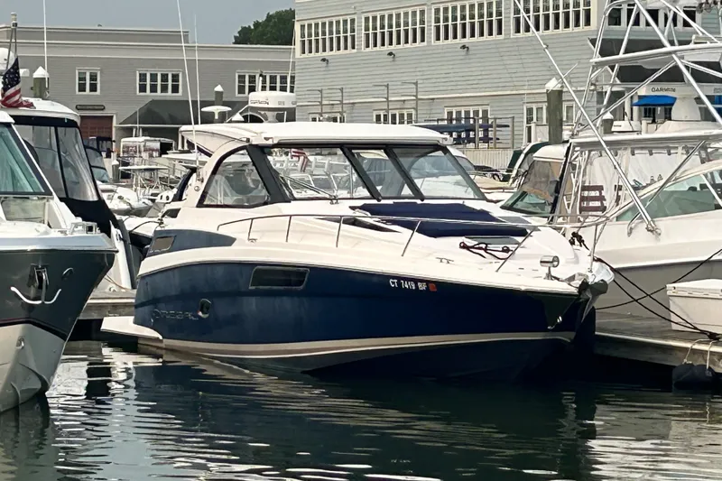 Sound Decision Yacht Photos Pics 2013 Regal 35 Sport Coupe docked at a marina, surrounded by other boats.