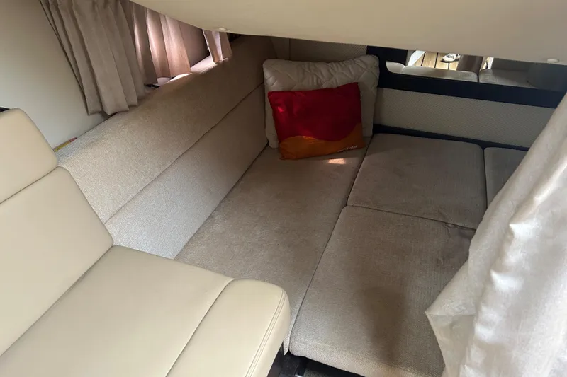 Sound Decision Yacht Photos Pics 2013 Regal 35 Sport Coupe interior with beige seating and red pillow.