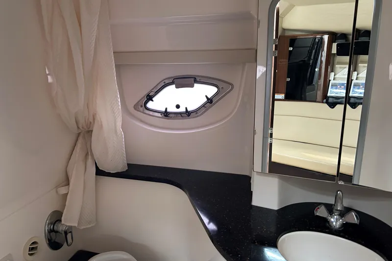 Sound Decision Yacht Photos Pics Interior of 2013 Regal 35 Sport Coupe bathroom with sink, mirror, and porthole window.