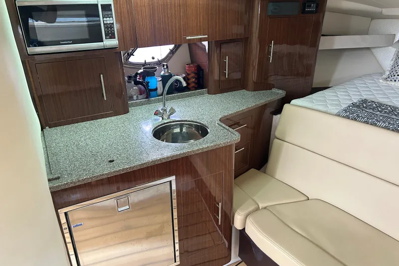 Sound Decision Yacht Photos Pics Interior of 2013 Regal 35 Sport Coupe with kitchenette and seating area.