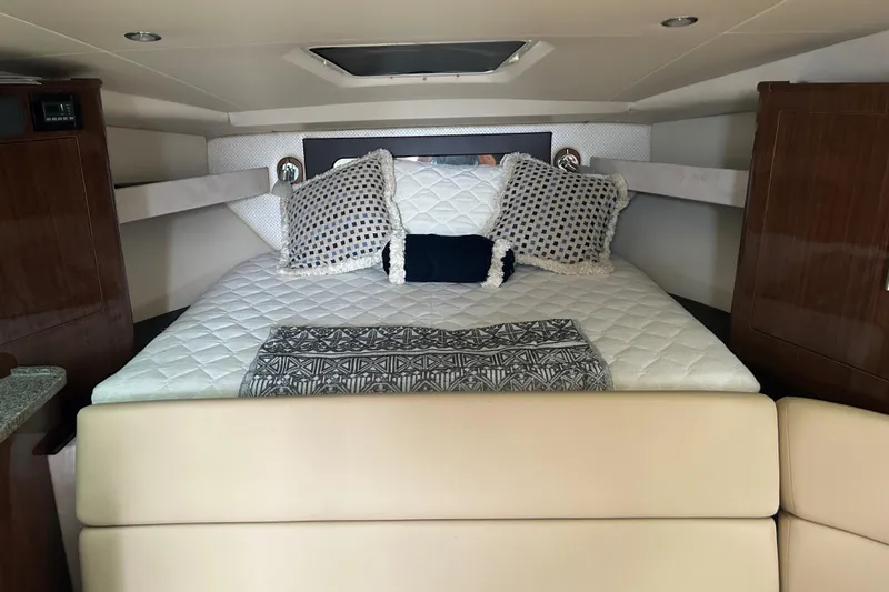 Sound Decision Yacht Photos Pics Luxurious cabin interior of 2013 Regal 35 Sport Coupe with cozy bedding.