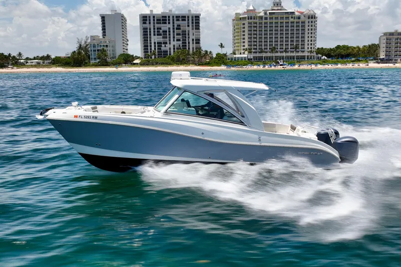  Yacht Photos Pics 2018 World Cat 320 DC cruising on ocean near beachfront buildings.